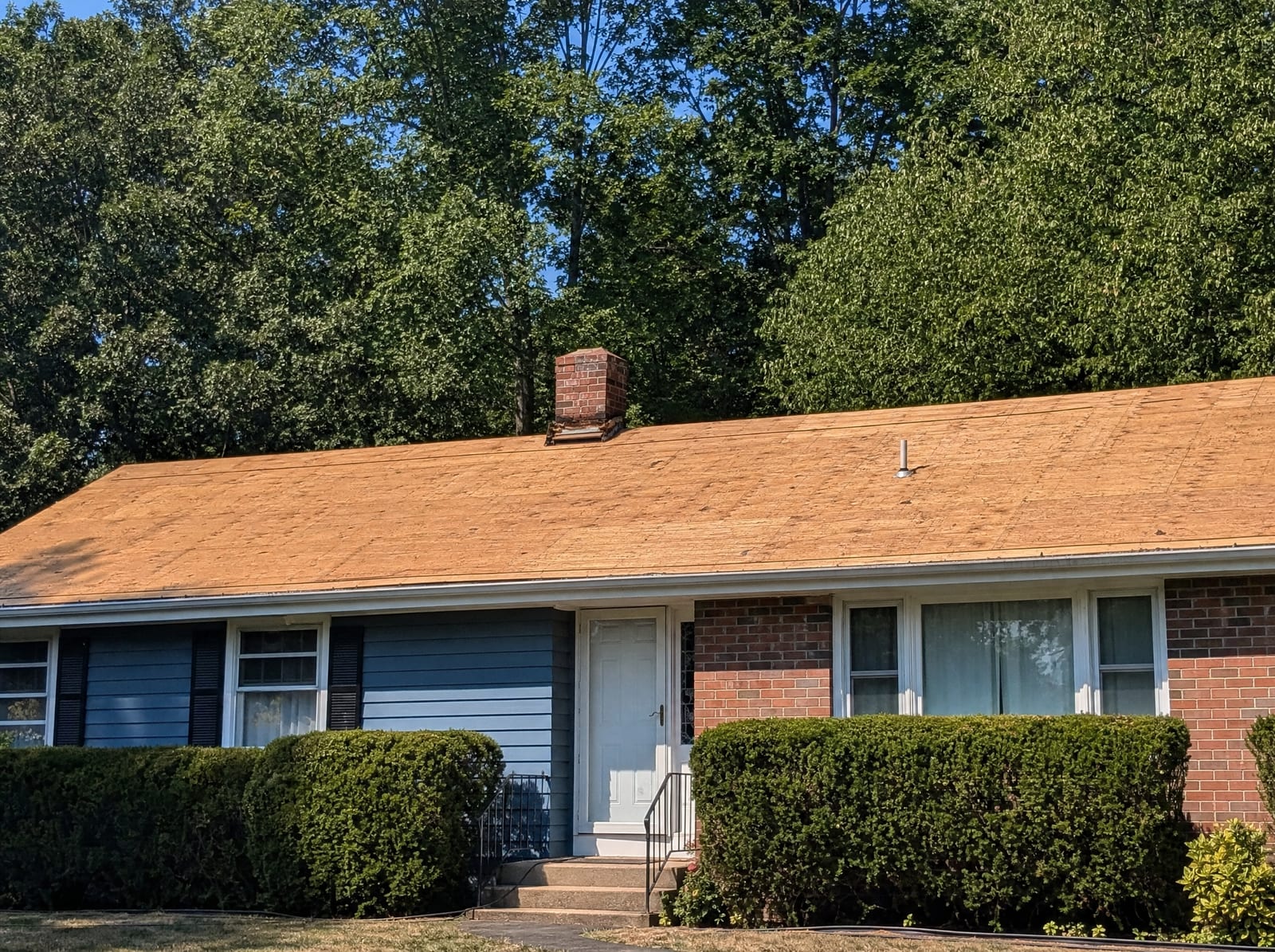 Roof stripped to bare wood decking on a Connecticut ranch, ready for new underlayment