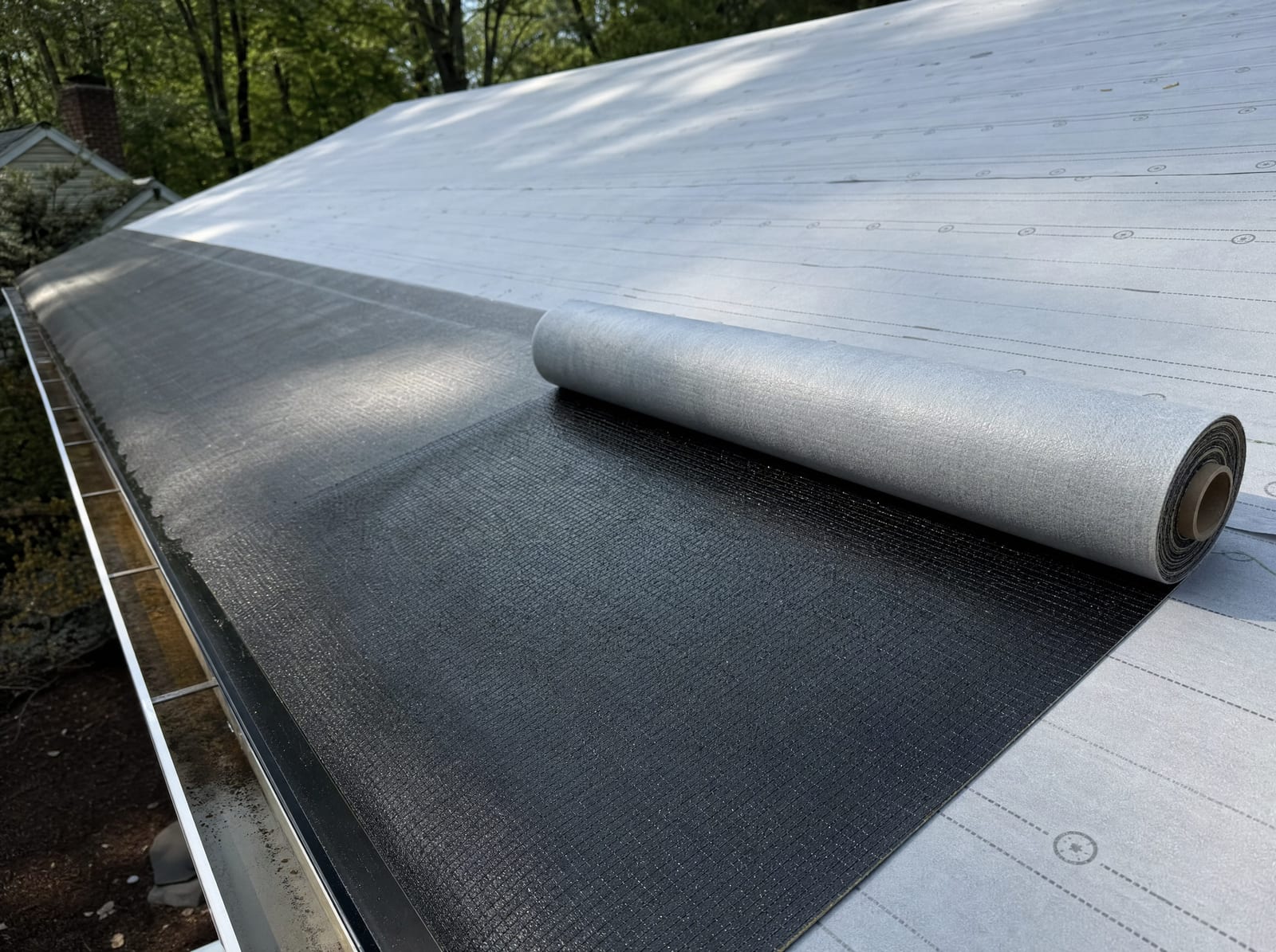 Ice-and-water shield and premium underlayment installed along a roof eave