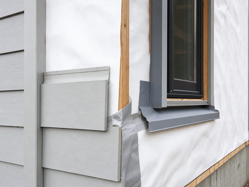Weather-resistive barrier and flashing on wall sheathing before siding installation