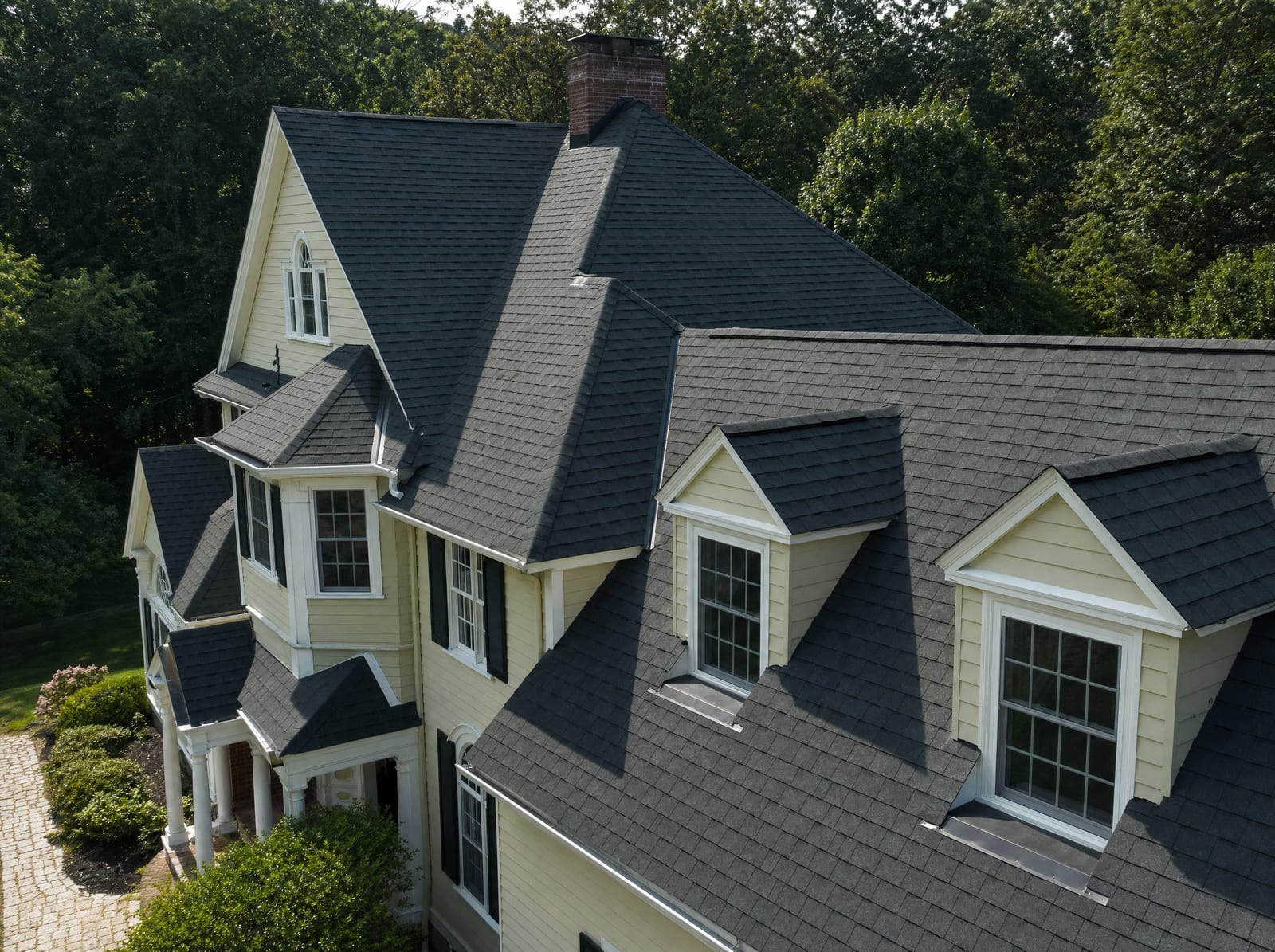 Complex roofline with multiple dormers, hips, and valleys on a large Connecticut colonial