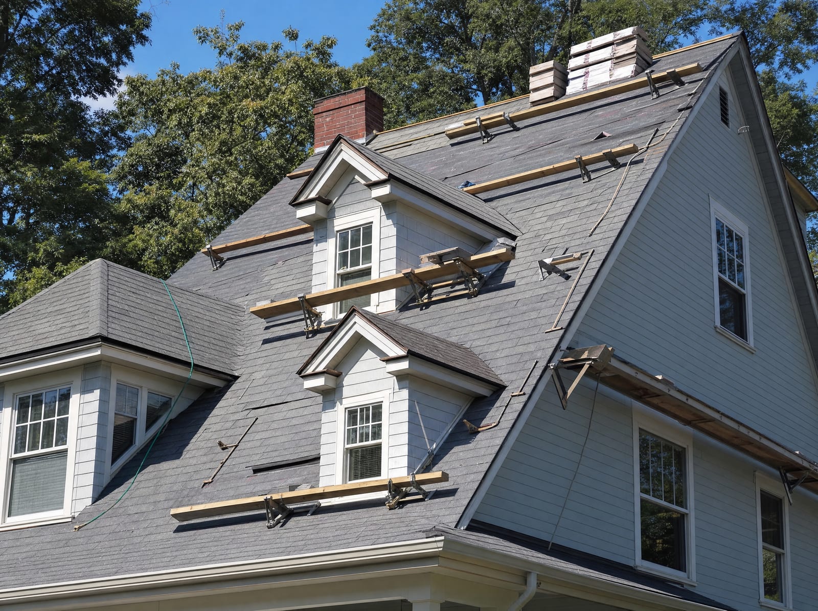Installation underway on a steep multi-dormer roof with staging for the complex pitch