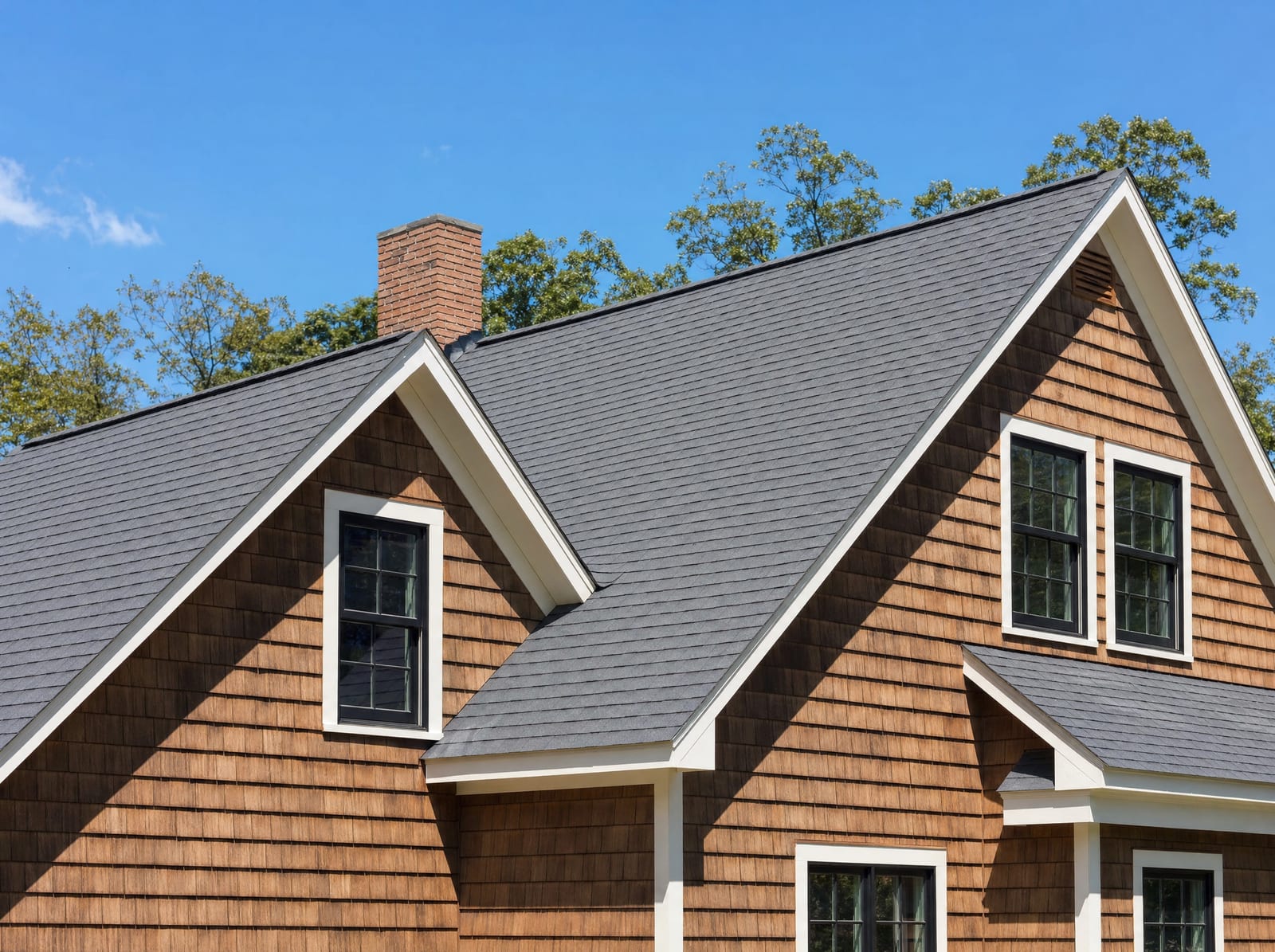 Expertly finished roof with crisp lines on a shaker-siding Connecticut home