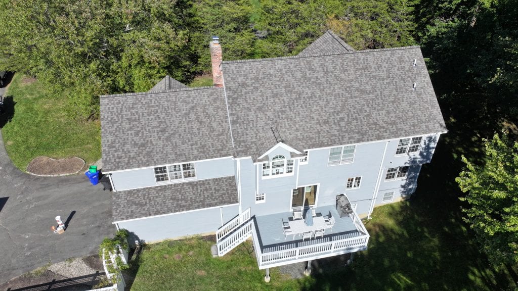 Freshly completed architectural asphalt shingle roof on a Central Connecticut colonial home, aerial view